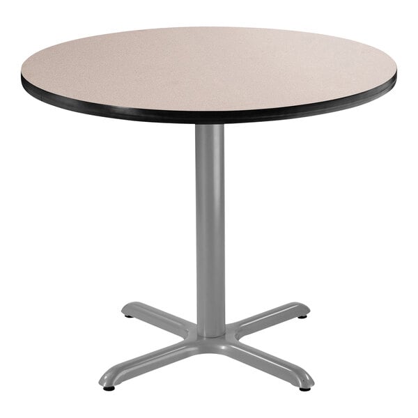 A National Public Seating round table with a gray top and metal X base.