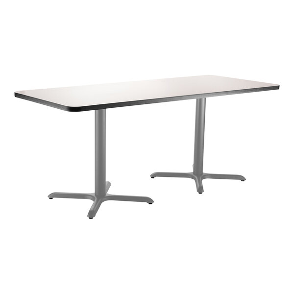 A rectangular gray National Public Seating cafe table with two gray metal legs.