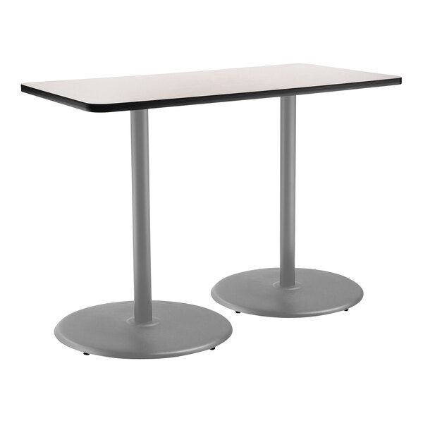A National Public Seating bar height cafe table with a gray top and gray frame on a round base with two legs.