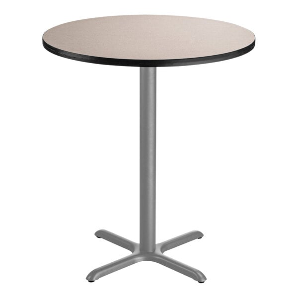 A round National Public Seating bar height table with a gray top and metal base.
