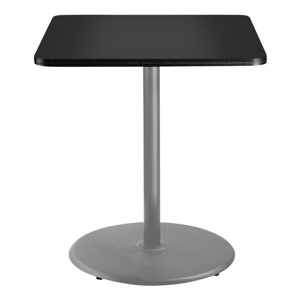 A black square National Public Seating bar height cafe table with a metal pole.