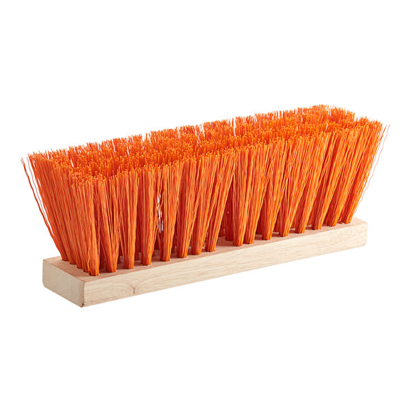 A close-up of a Lavex wood street broom head with orange bristles.