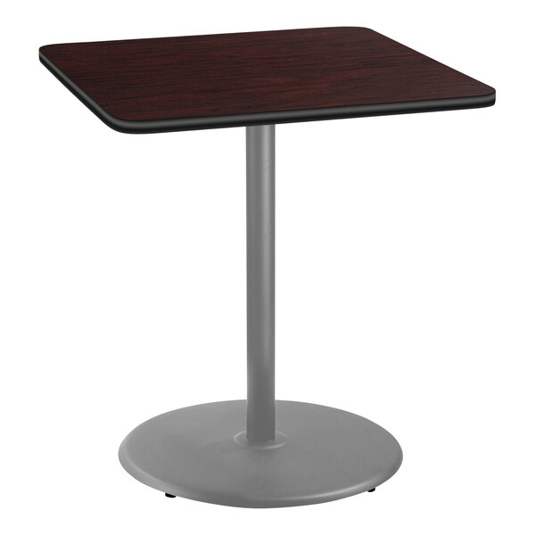 A National Public Seating bar height table with a mahogany top and metal base.