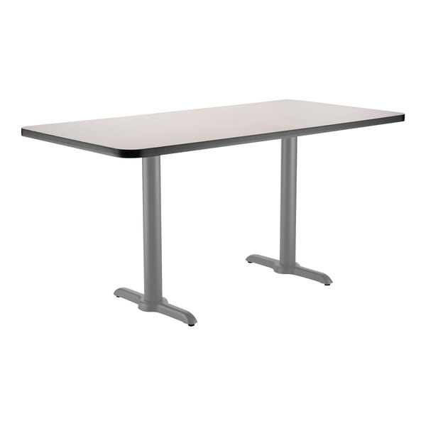 A rectangular National Public Seating cafe table with a grey T base.