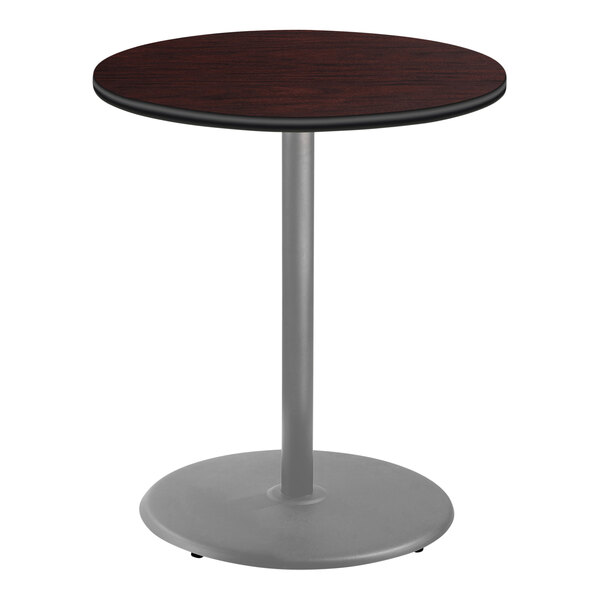A National Public Seating round table with a mahogany top and metal base.
