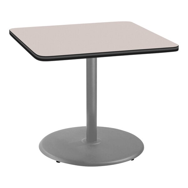 A square table with a gray base and a beige top.