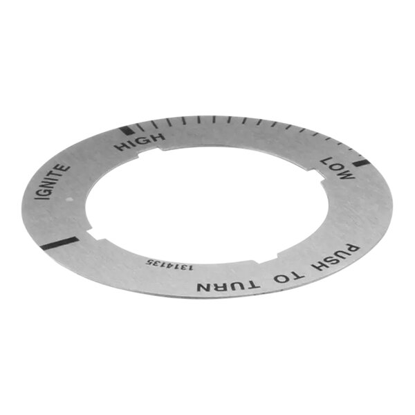 A circular metal Garland dial insert with numbers.