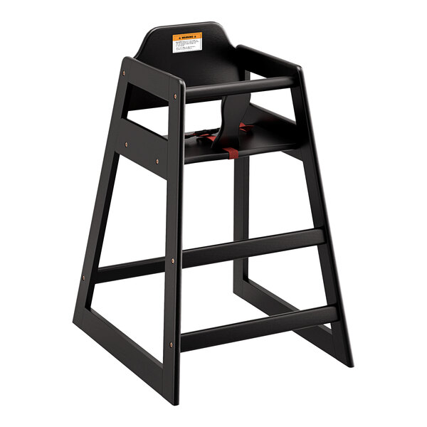 A Lancaster Table & Seating black wooden high chair with a red strap.