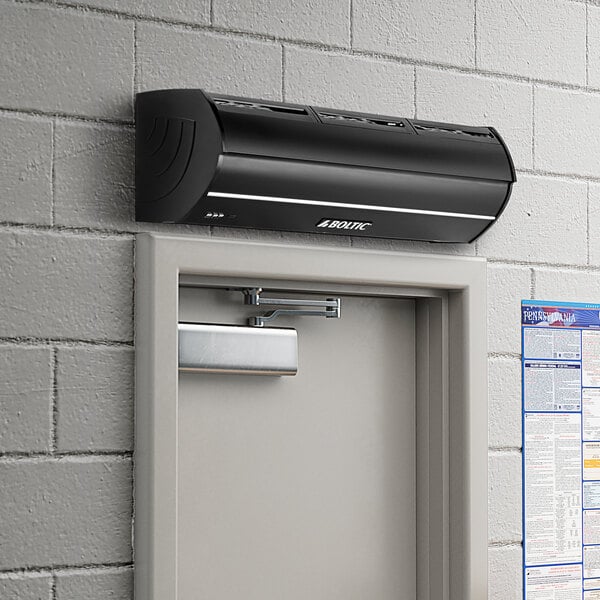 A black Boltic air curtain mounted above a door.