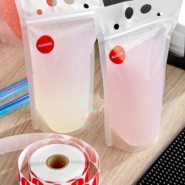 A plastic bag with a roll of Point Plus red alcohol labels with red dots on it.