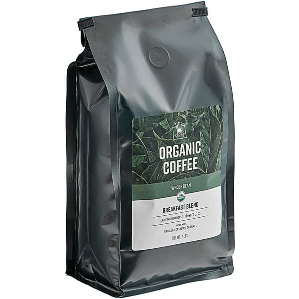 A white bag of Crown Beverages Organic Breakfast Blend Whole Bean Coffee with a label.