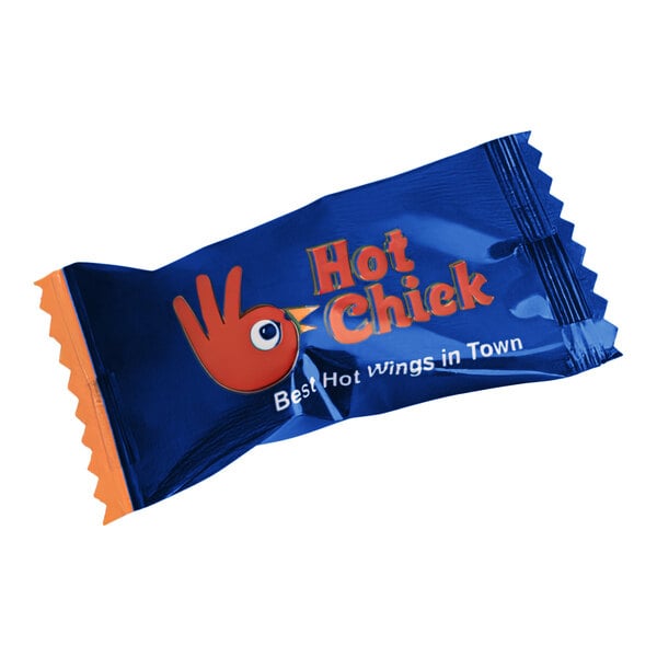 A navy blue package of individually wrapped cinnamon starlites with orange text and a red hand.