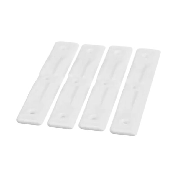 A group of four white plastic Spaceman scraper blades.