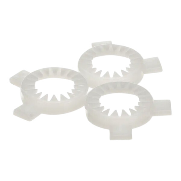 A close-up of three white circular plastic gears.