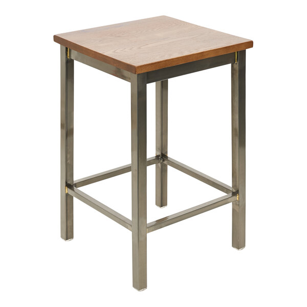 A BFM Seating wood and metal counter height bar stool with a wooden seat on a table.