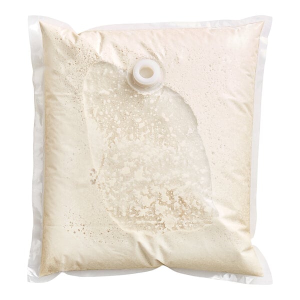 A white liquid in a white bag with a hole in it.