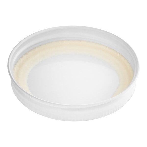 A white metal lid with a plastisol liner on a white background.