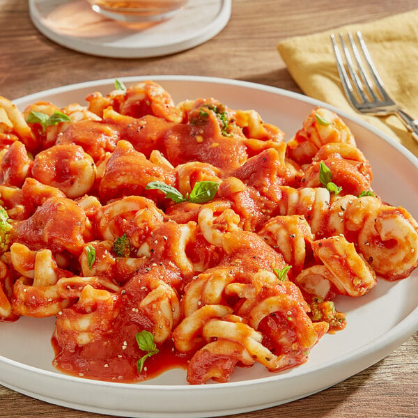 A plate of pasta with RedPack tomato puree and a fork.