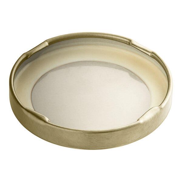 A 58 gold metal lid with a white plastisol liner.