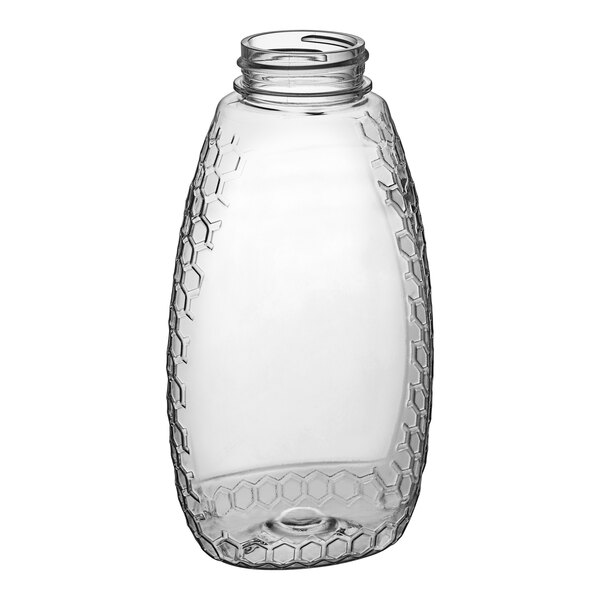 A clear PET bottle of honeycomb honey with a white lid.