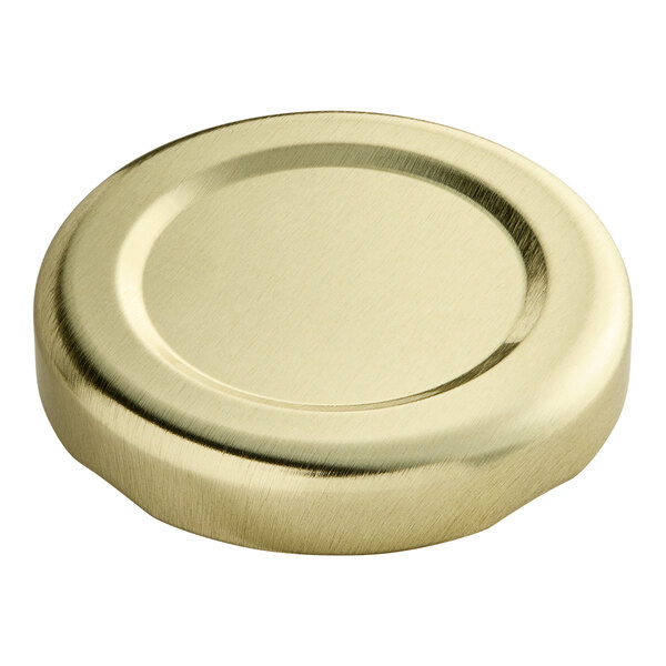 A gold metal lid for a 43 lug with a plastisol liner.