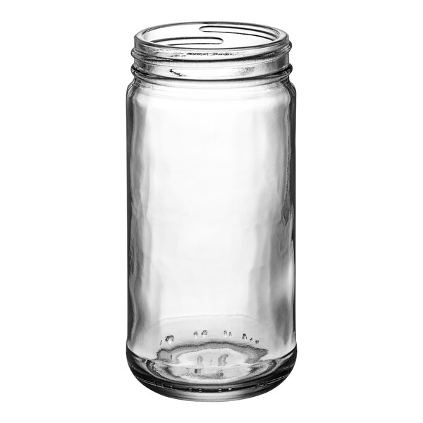 A close-up of a 6.5 oz. clear Paragon glass jar with a lid.