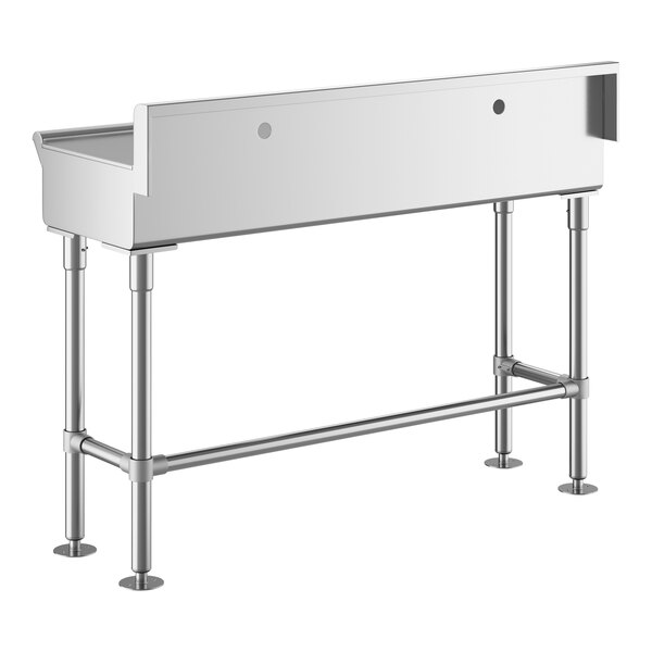 A stainless steel hand sink with four legs, a rectangular basin, and two faucet holes on the back panel.