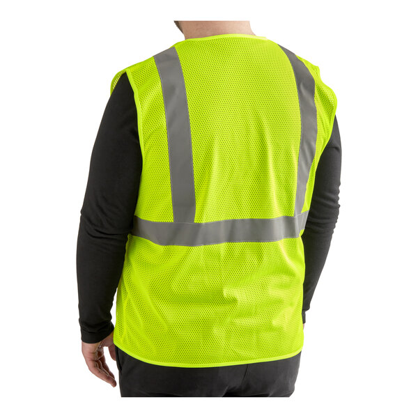 A man wearing a small yellow Lavex high visibility safety vest with reflective stripes.