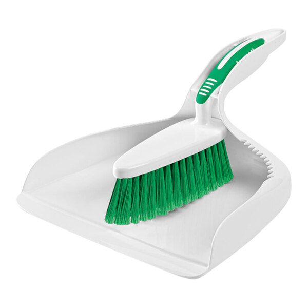 A white surface with a green and white Libman dustpan and brush set.