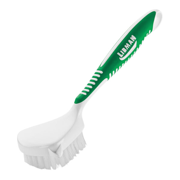 A close-up of a white and green Libman culinary brush.