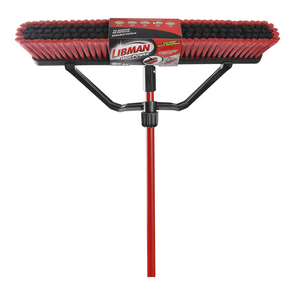 A box containing three red Libman multi-surface push brooms with black bristles and steel handles.