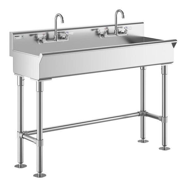 A Regency stainless steel hand sink with two faucets.