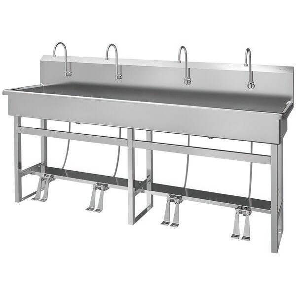 A stainless steel Sani-Lav multi-station floor-mounted utility sink with 4 foot-operated faucets.