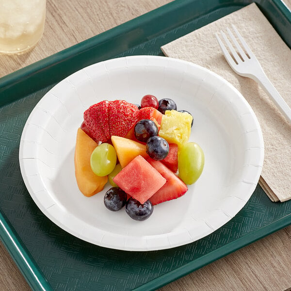 A white Choice paper plate with a variety of fruit on it.