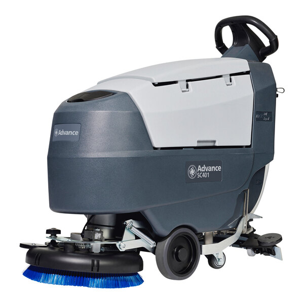 An Advance SC401 walk behind floor scrubber with blue brushes on it.