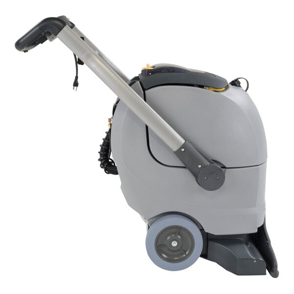An Advance grey and black carpet extractor with a handle and wheels.