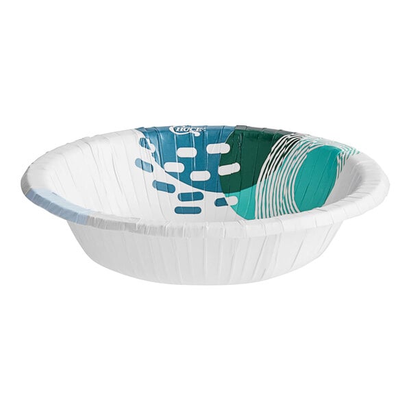 A white paper bowl with a blue and green design on it.