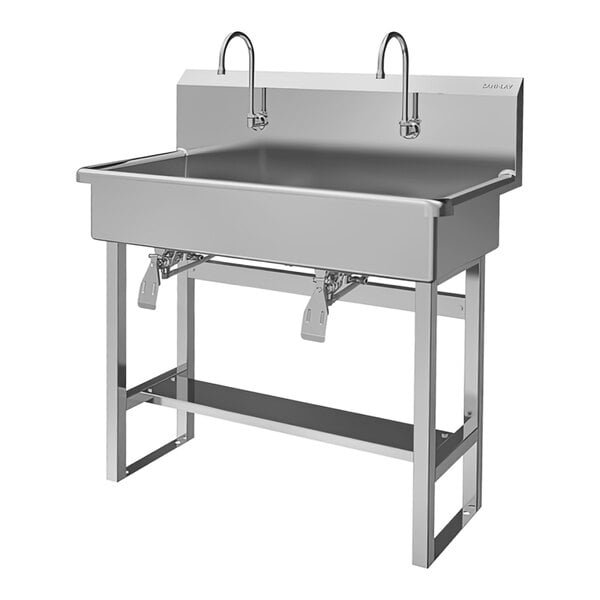 A stainless steel Sani-Lav floor-mounted utility sink with two knee-operated faucets.