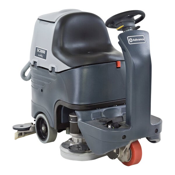 An Advance SC3000 ride-on floor scrubber with wheels and a handle.