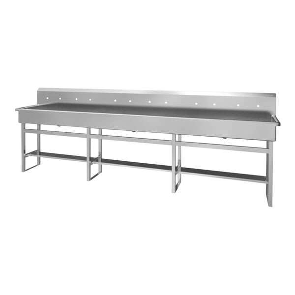 A large stainless steel floor-mounted multi-station hand sink with 6 faucets.
