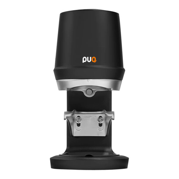 A black PUQpress Q1 espresso tamper with silver accents on a table.