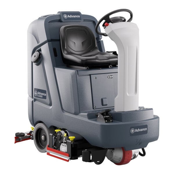 A black and grey Advance SC4000 ride-on floor scrubber with a seat and wheels.