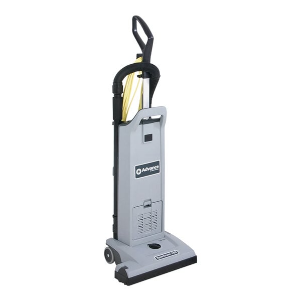 A grey rectangular Advance Spectrum 15D vacuum cleaner with yellow and black cables and handles.