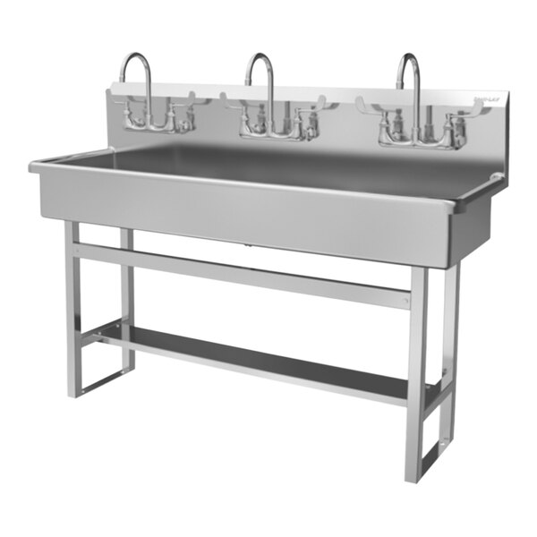 A stainless steel Sani-Lav floor-mounted multi-station hand sink with three faucets.