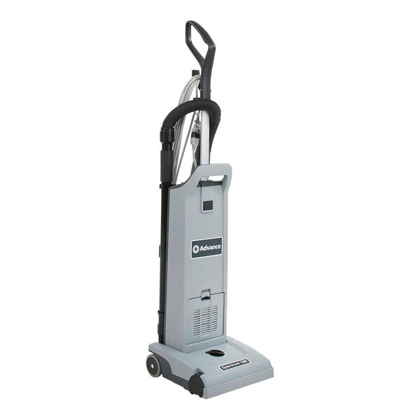 A grey Advance Spectrum upright vacuum cleaner with black wheels.