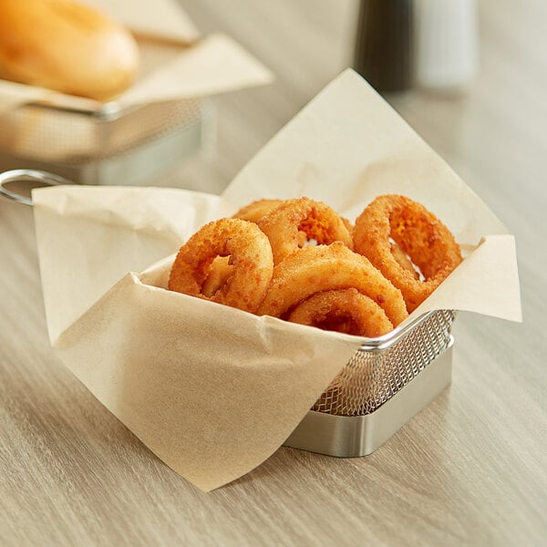 A basket lined with a natural kraft deli wrap filled with fried onion rings.