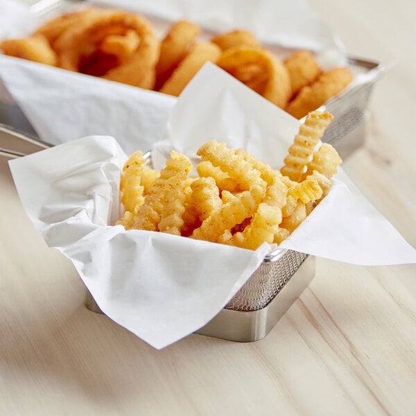 A basket filled with french fries on a table.