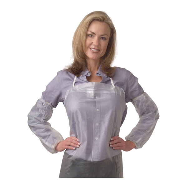A woman in a white shirt and plastic sleeves with her hands on her hips.