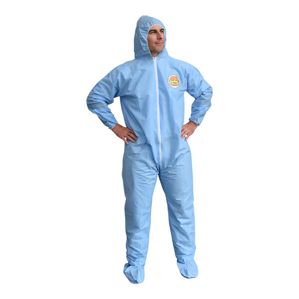 A man wearing blue Cordova coveralls with boots and an elastic hood.