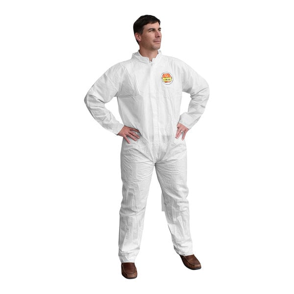 A man in Cordova white protective coveralls standing with his hands on his hips.